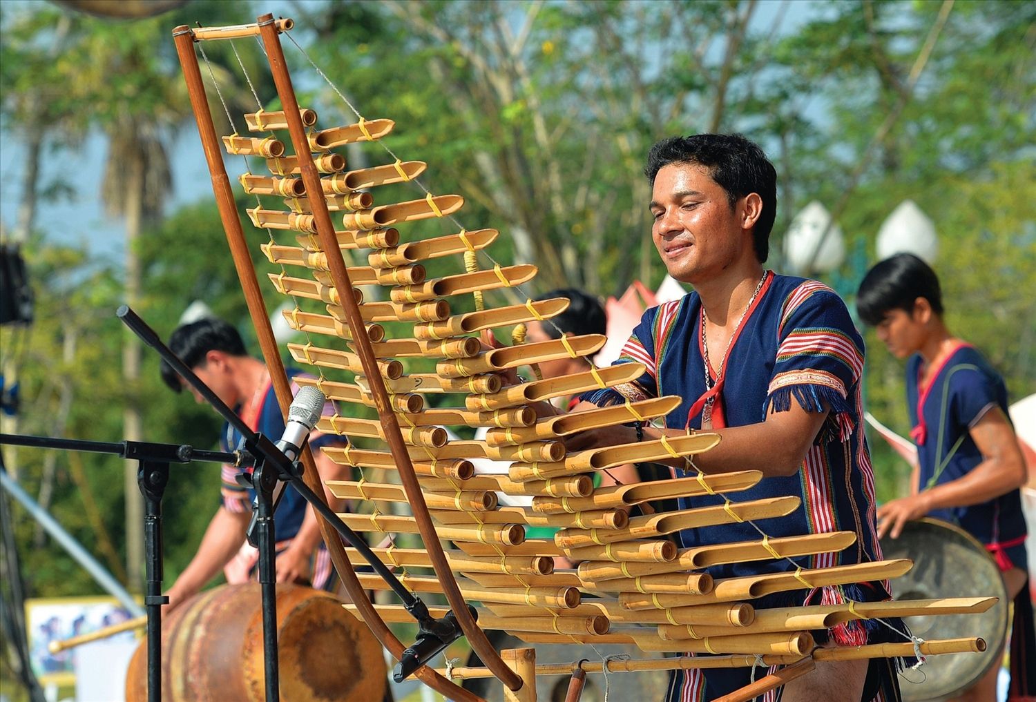 Vibrant festival scene showing traditional Vietnamese instruments being played during a cultural celebration